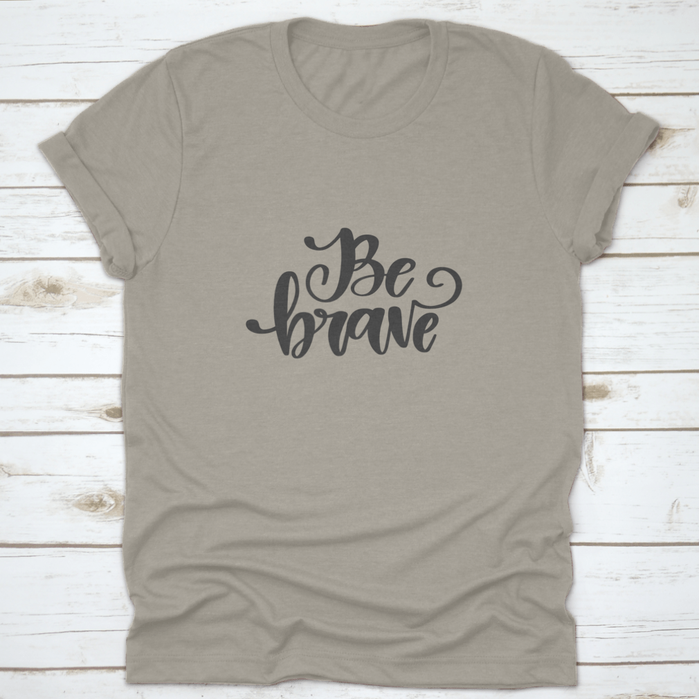 Vector hand drawn t-shirt featuring the motivational quote 'Be Brave' on a soft cotton fabric, showcasing a classic fit and stylish design.