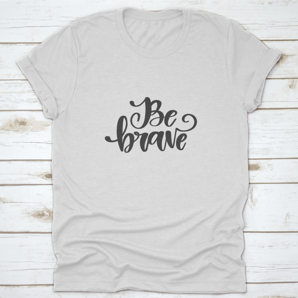 Vector hand drawn t-shirt featuring the motivational quote 'Be Brave' on a soft cotton fabric, showcasing a classic fit and stylish design.