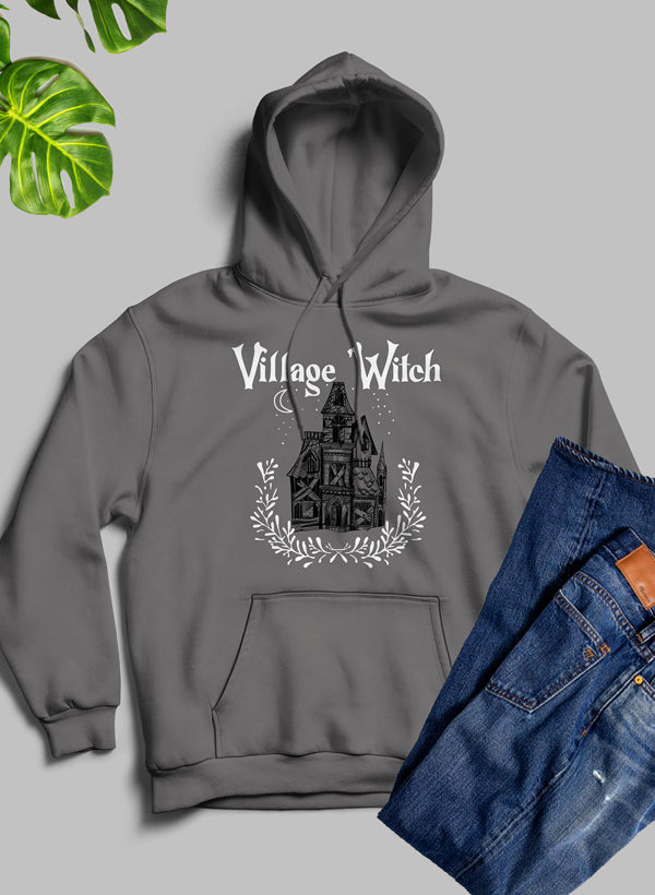 A stylish Village Witch Hoodie featuring unique artistic designs, made from warm fleece blend material with an adjustable hood.