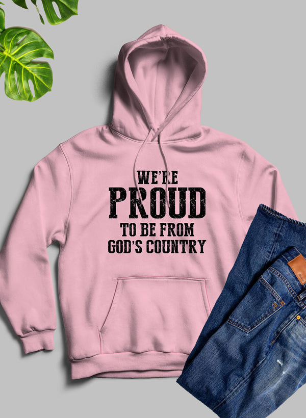 A cozy hoodie featuring the phrase 'We're Proud To Be From God's Country', designed with a fleece blend for warmth and comfort.