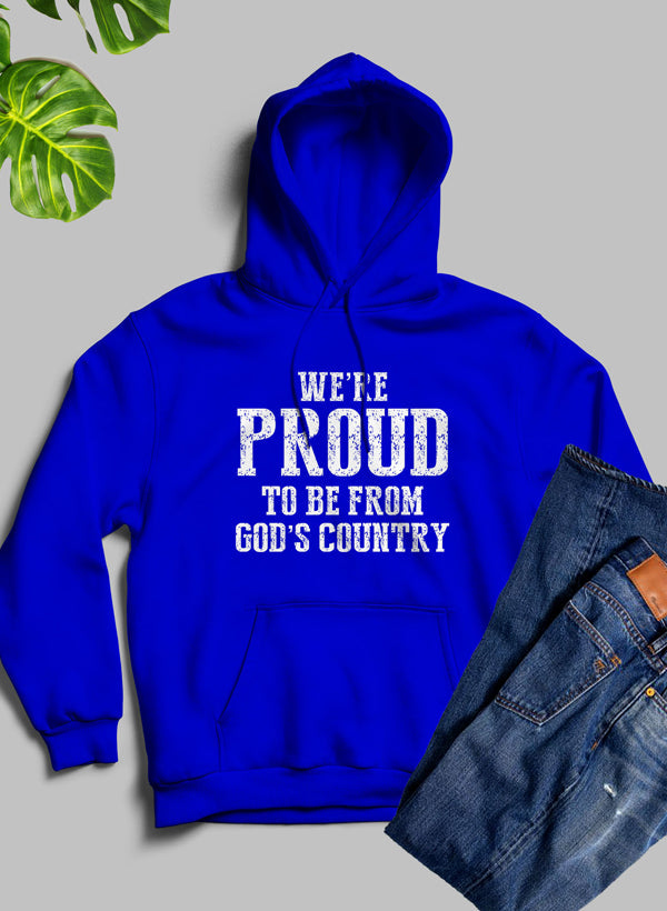 A cozy hoodie featuring the phrase 'We're Proud To Be From God's Country', designed with a fleece blend for warmth and comfort.