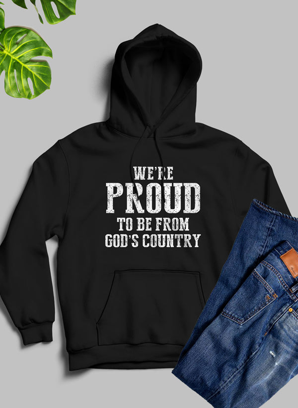 A cozy hoodie featuring the phrase 'We're Proud To Be From God's Country', designed with a fleece blend for warmth and comfort.