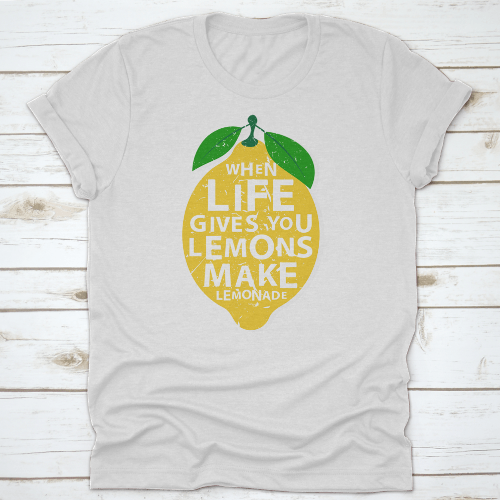 A motivational t-shirt featuring the phrase 'When Life Gives You Lemons, Make Lemonade' in a vibrant lemon-themed design.