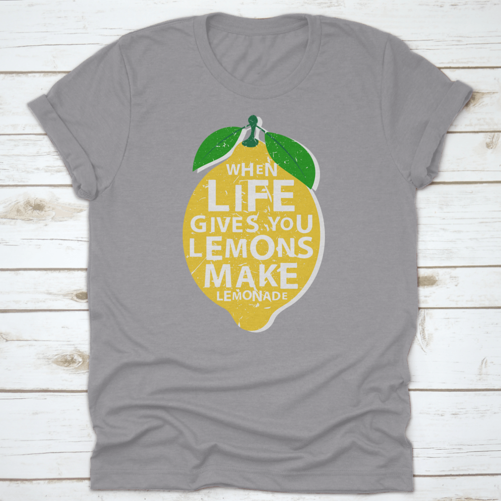 A motivational t-shirt featuring the phrase 'When Life Gives You Lemons, Make Lemonade' in a vibrant lemon-themed design.