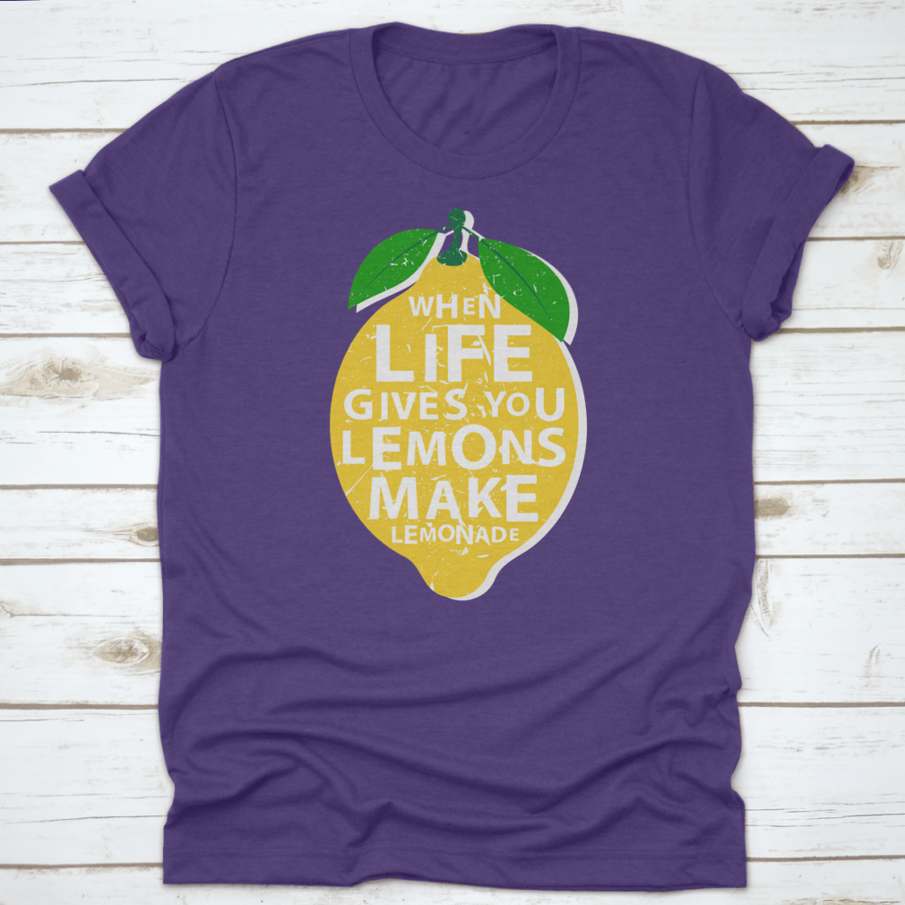 A motivational t-shirt featuring the phrase 'When Life Gives You Lemons, Make Lemonade' in a vibrant lemon-themed design.