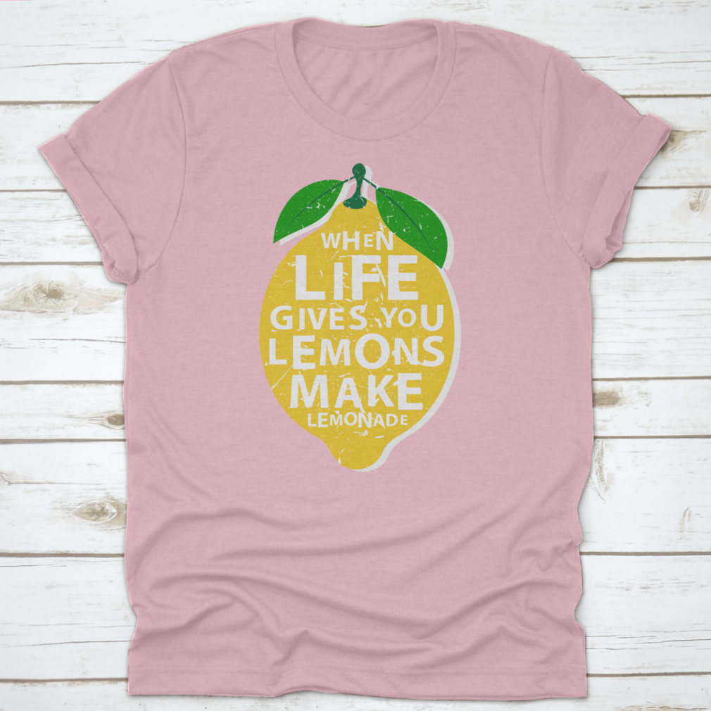 A motivational t-shirt featuring the phrase 'When Life Gives You Lemons, Make Lemonade' in a vibrant lemon-themed design.