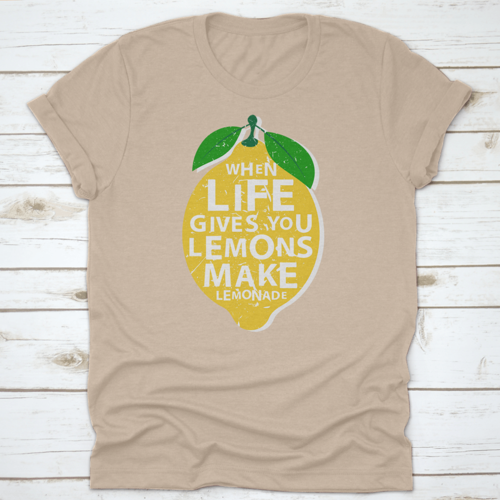 A motivational t-shirt featuring the phrase 'When Life Gives You Lemons, Make Lemonade' in a vibrant lemon-themed design.