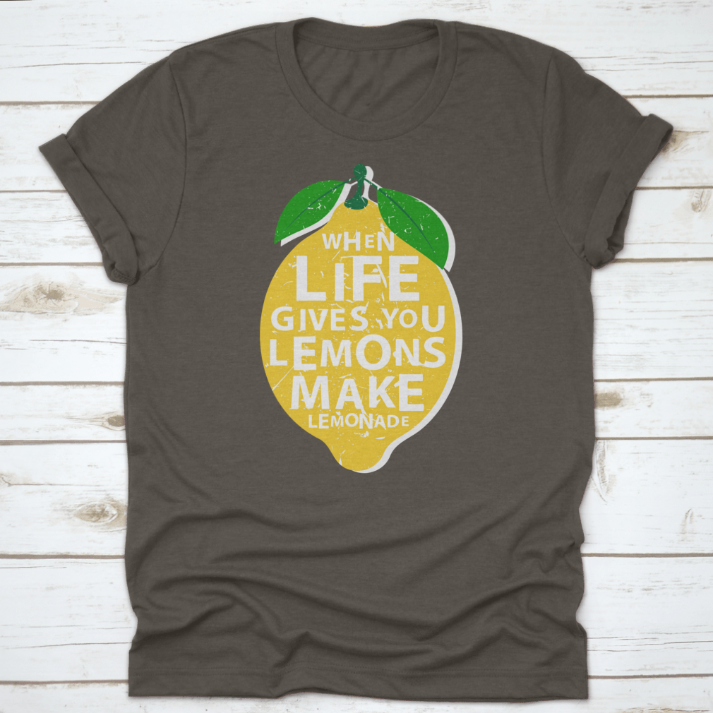 A motivational t-shirt featuring the phrase 'When Life Gives You Lemons, Make Lemonade' in a vibrant lemon-themed design.