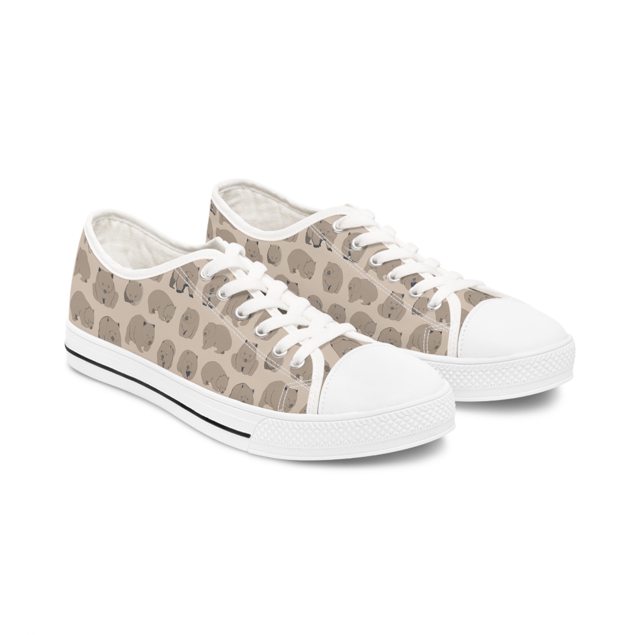 Wombat Women's Low Top Sneakers in black and white, featuring breathable canvas and stylish design with silver metal eyelets.