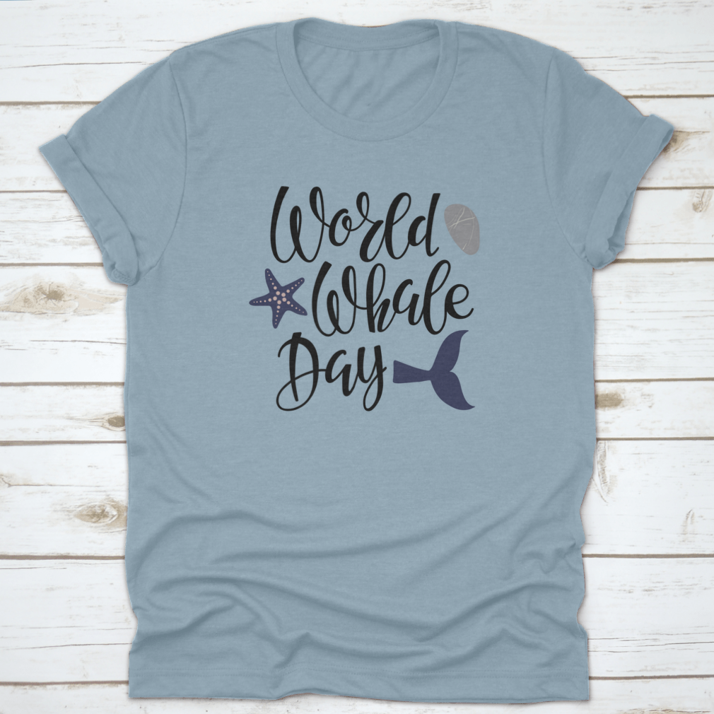 Handwritten calligraphy lettering design celebrating World Whale Day on a cotton apparel piece, showcasing marine life appreciation.