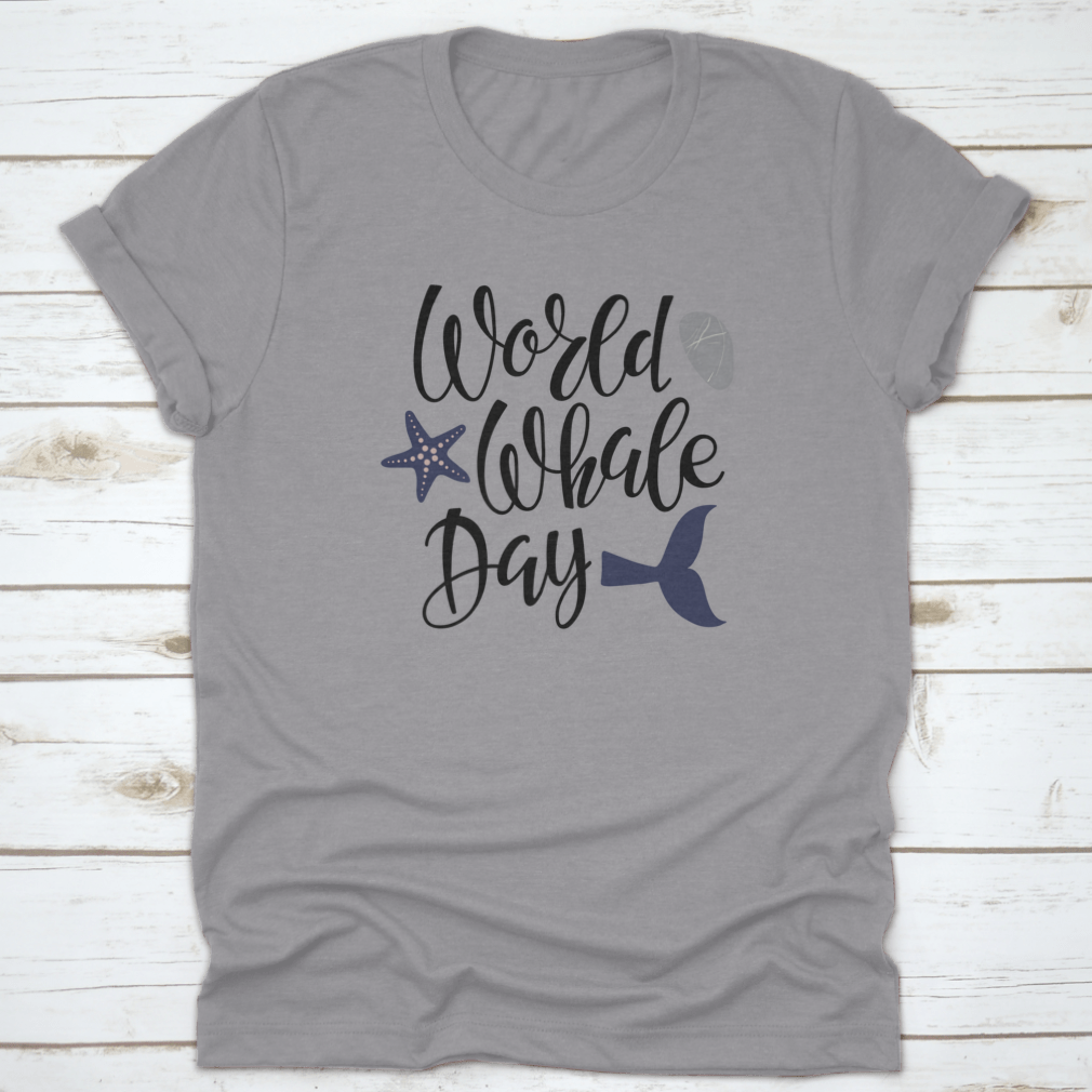 Handwritten calligraphy lettering design celebrating World Whale Day on a cotton apparel piece, showcasing marine life appreciation.