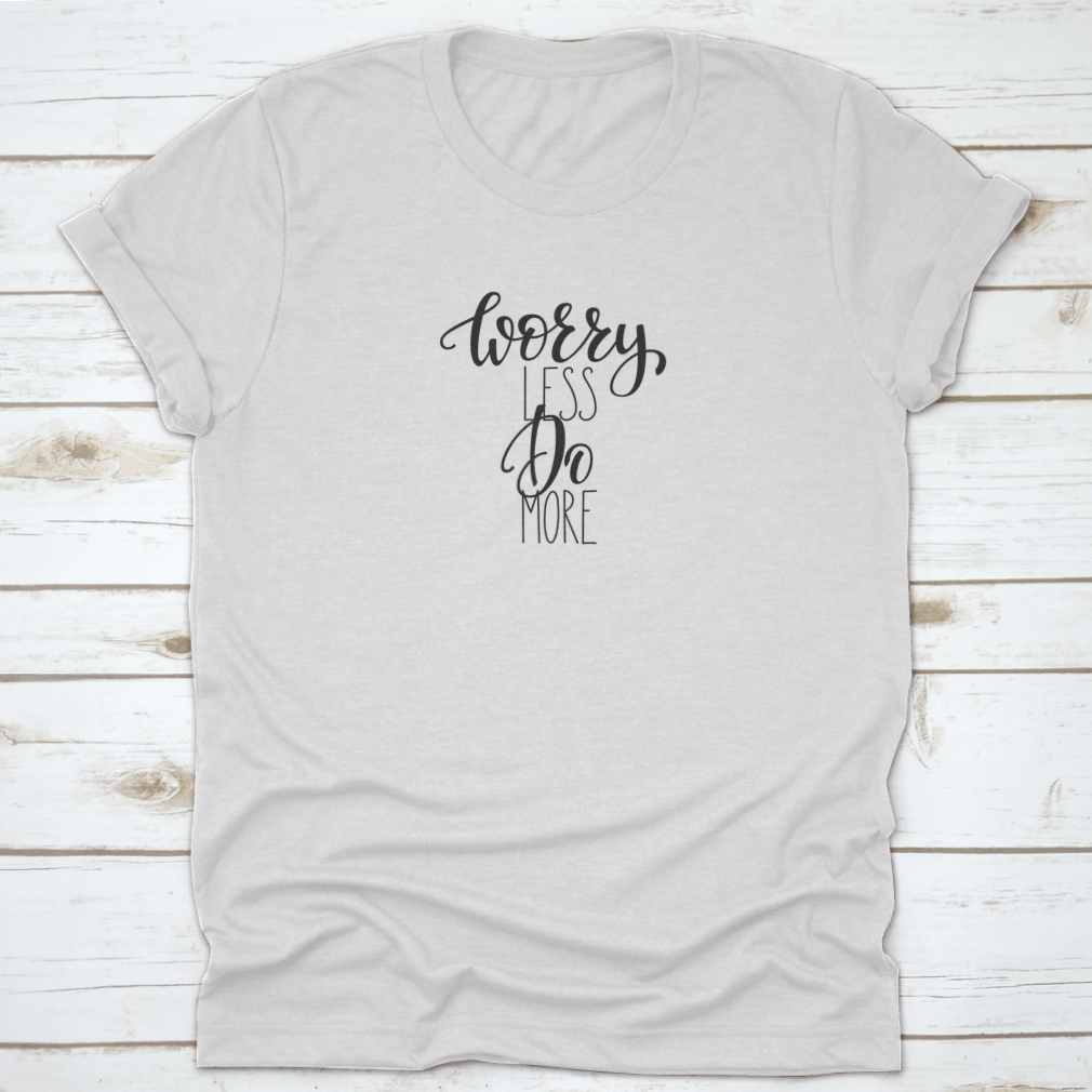 A stylish cotton tee featuring the inspirational quote 'Worry Less Do More' in elegant calligraphy lettering.