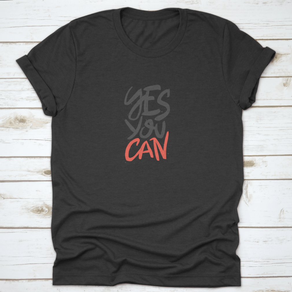 A stylish t-shirt featuring the motivational quote 'Yes You Can' in vector brush lettering, showcasing a classic fit and high-quality fabric.