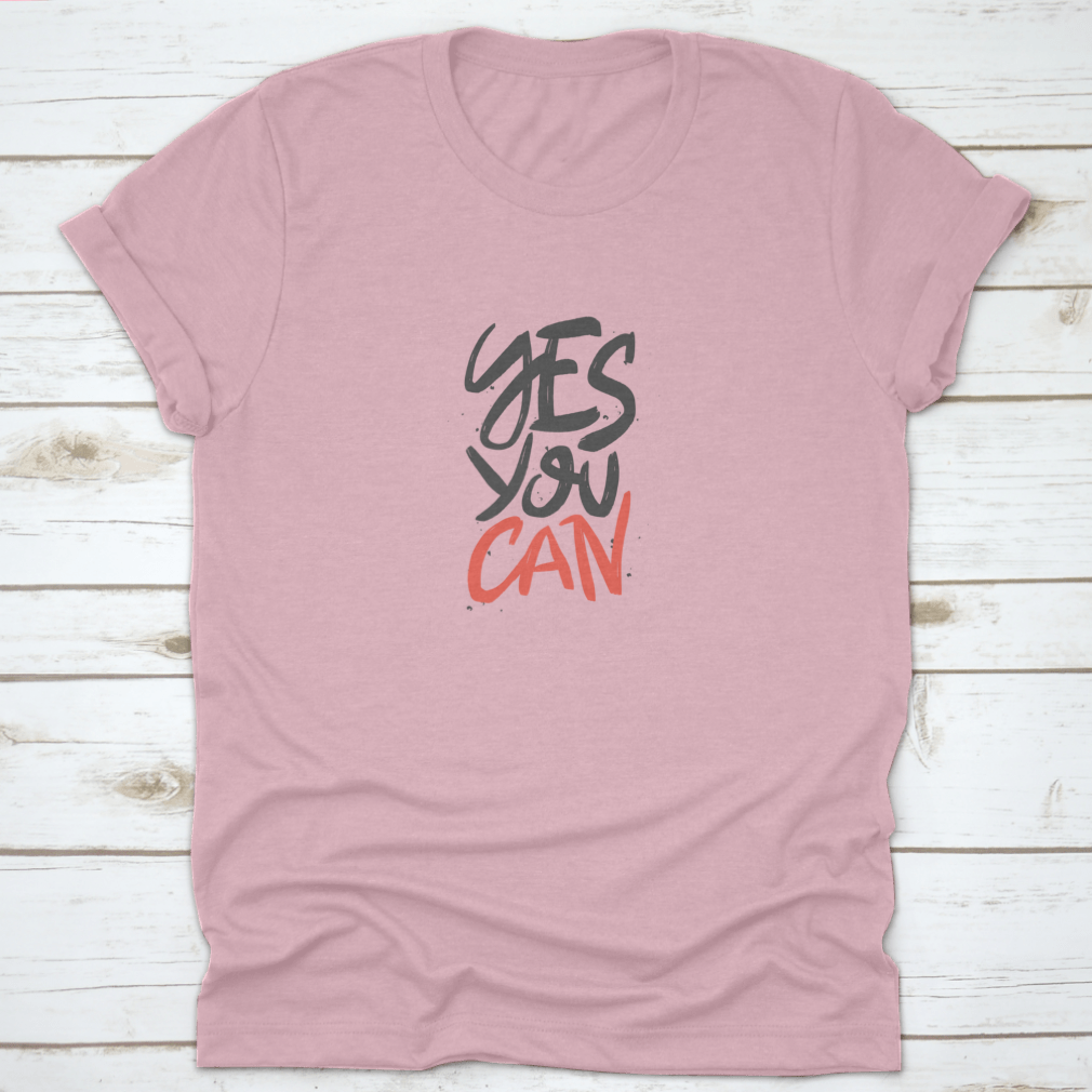 A stylish t-shirt featuring the motivational quote 'Yes You Can' in vector brush lettering, showcasing a classic fit and high-quality fabric.