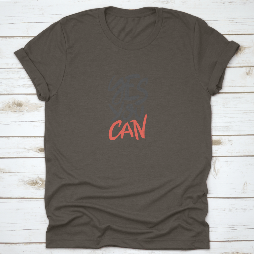 A stylish t-shirt featuring the motivational quote 'Yes You Can' in vector brush lettering, showcasing a classic fit and high-quality fabric.