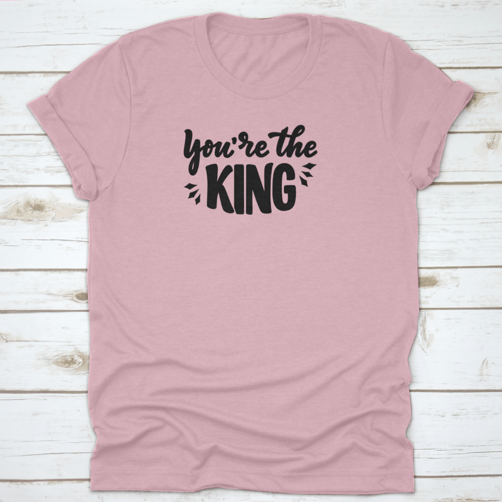 A stylish T-shirt featuring the hand-drawn phrase 'You're The King' in modern lettering, made from soft cotton fabric.