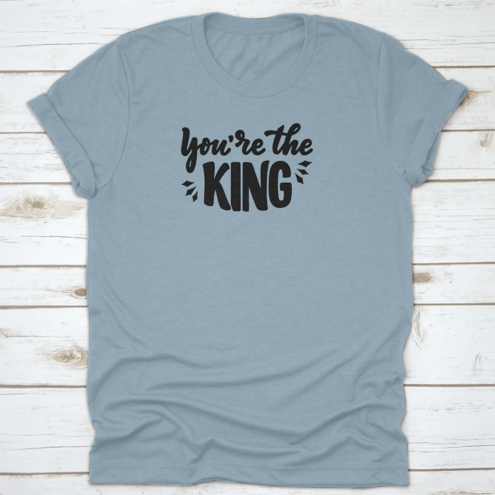 A stylish T-shirt featuring the hand-drawn phrase 'You're The King' in modern lettering, made from soft cotton fabric.