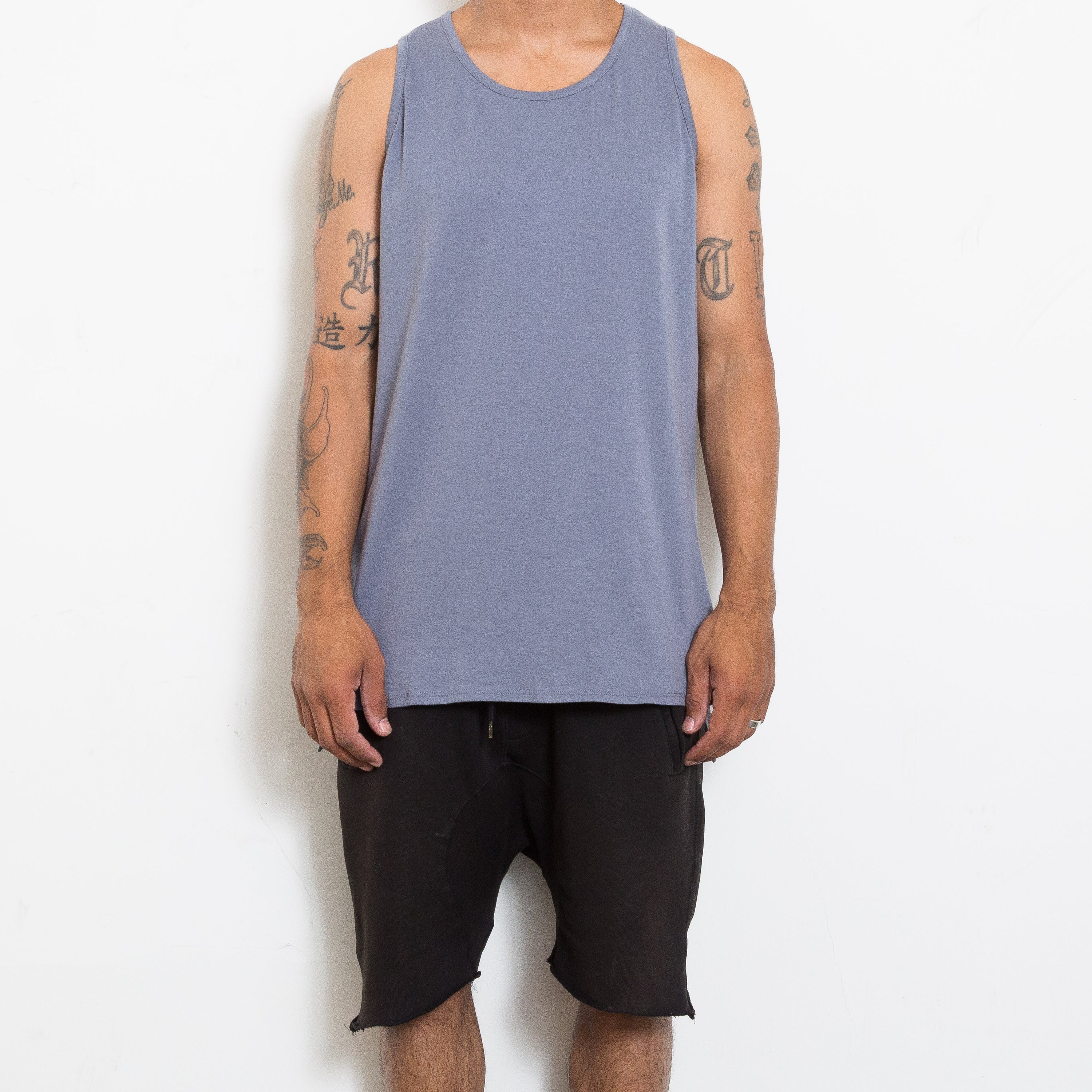 A stylish BASIC TANK featuring a hi-low design and muscle tank style, made from super-soft fabric, perfect for layering.