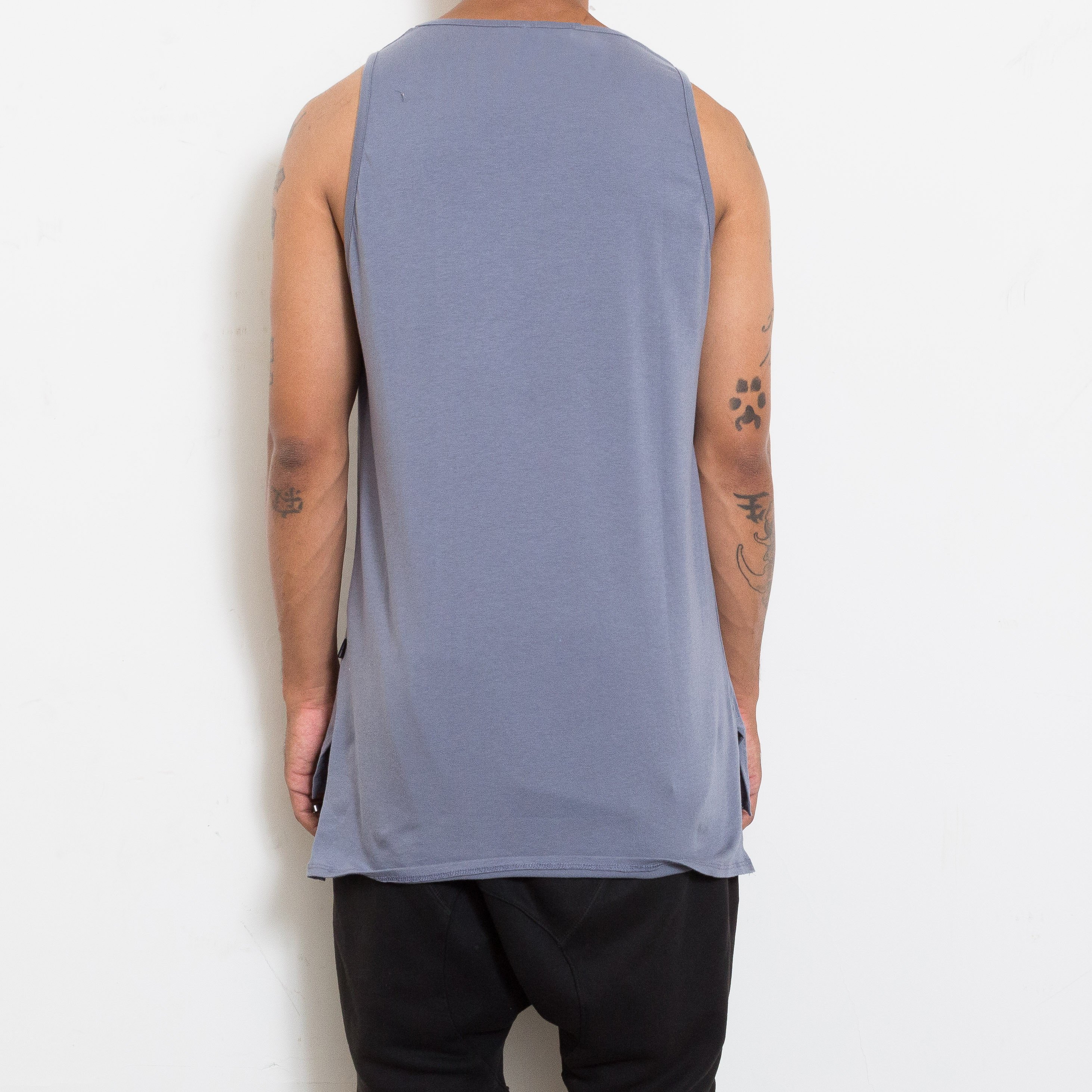 A stylish BASIC TANK featuring a hi-low design and muscle tank style, made from super-soft fabric, perfect for layering.