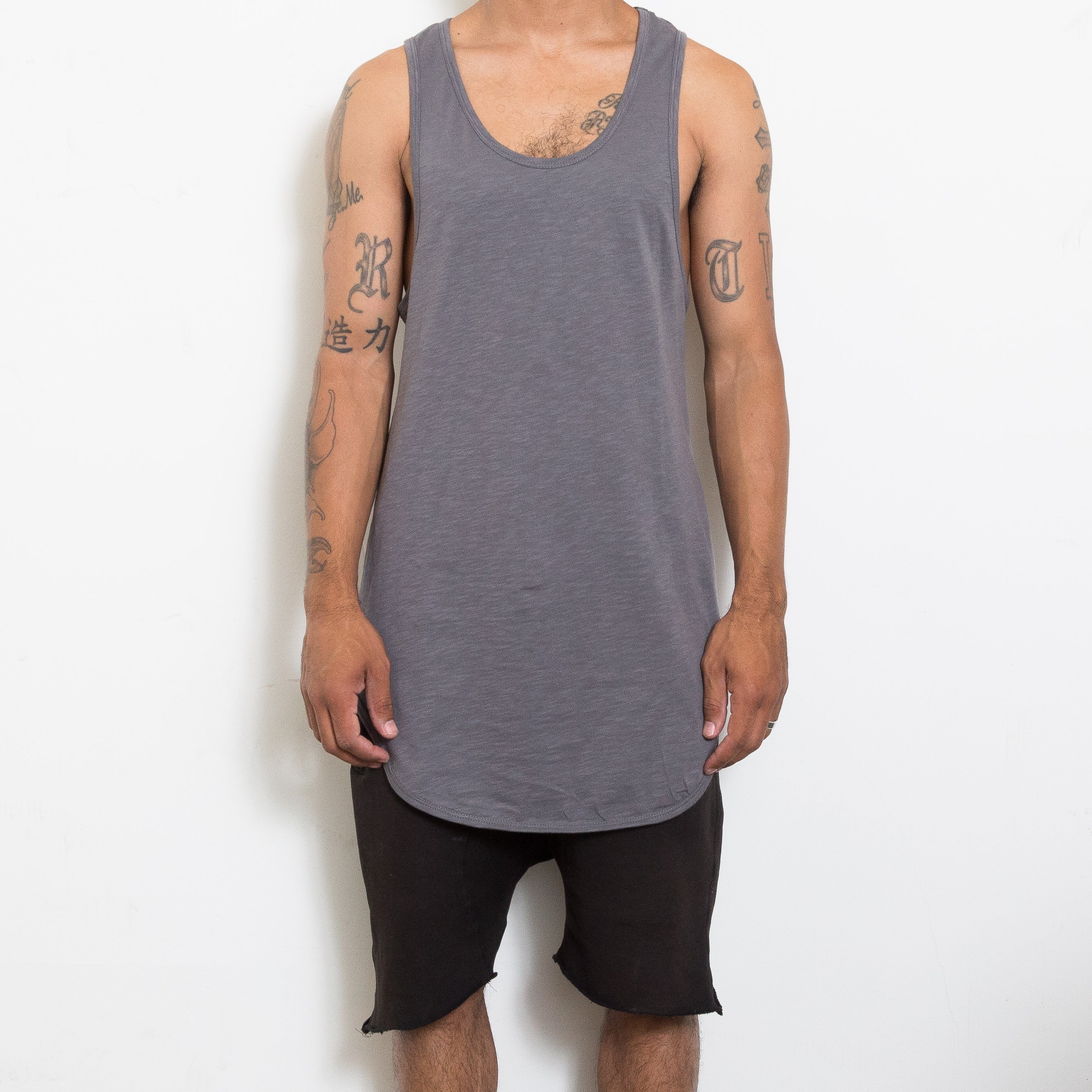 A stylish Capsule Layer Tank Top featuring an extended scoop neckline and muscle tank design, perfect for layering or casual wear.