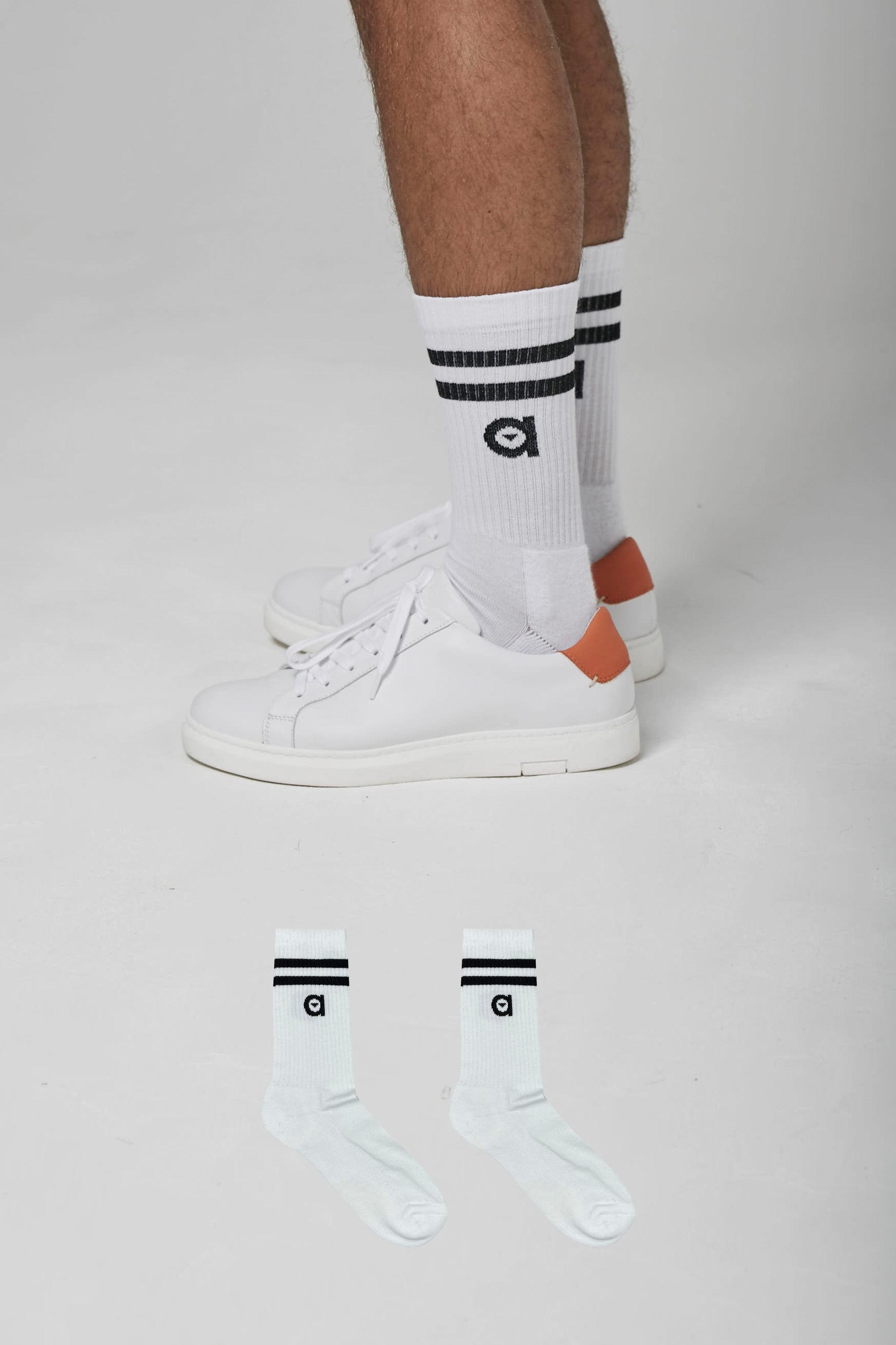 A pair of black striped socks from altid, showcasing their soft texture and stylish design.