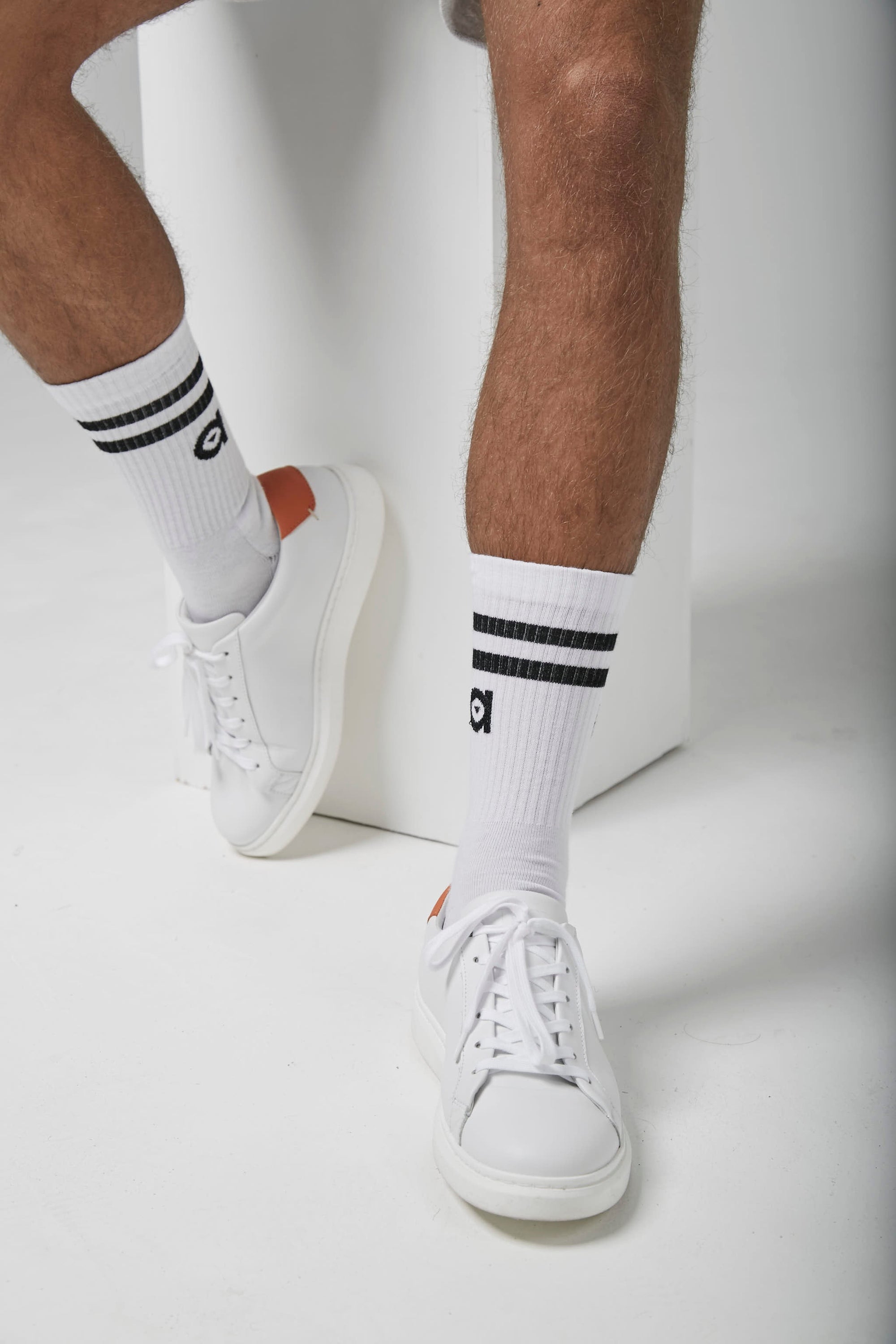 A pair of black striped socks from altid, showcasing their soft texture and stylish design.