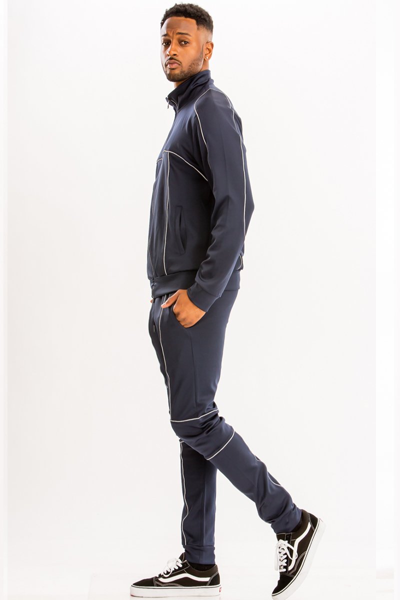 3M Reflective Pipe Track Set featuring reflective details, elastic waist, and standard pockets, modeled by a person standing at 5'11 in a Medium size.