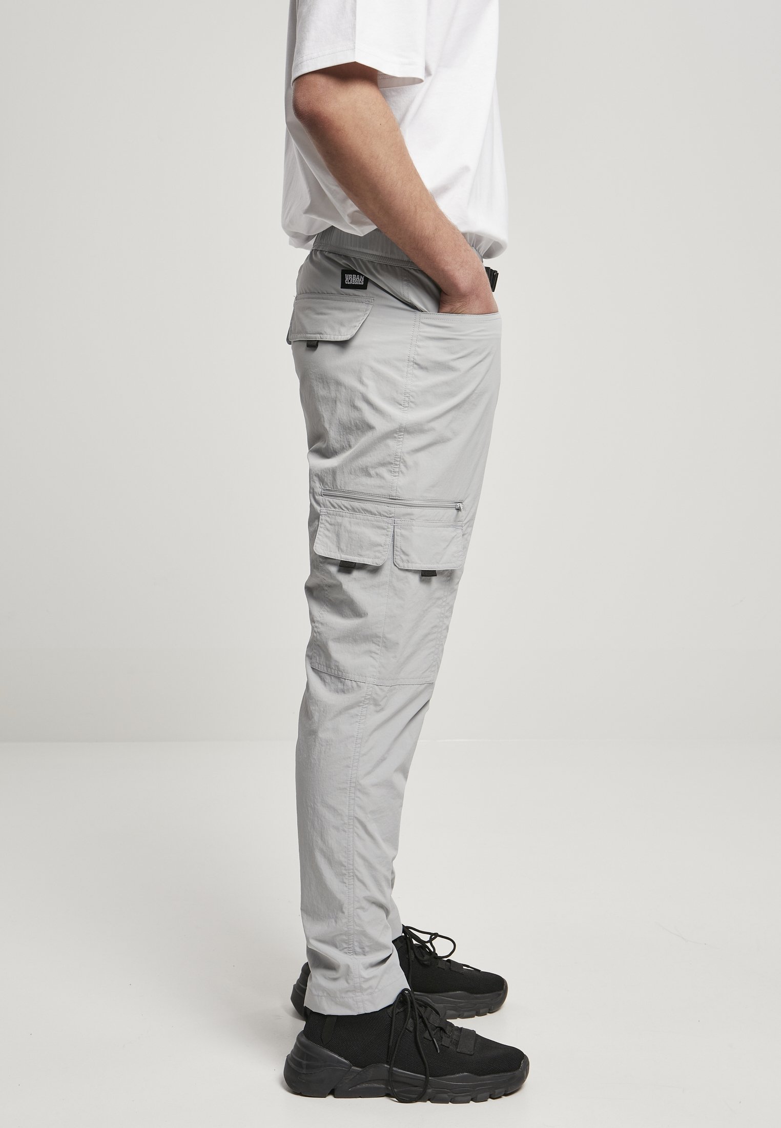 Men's adjustable nylon cargo pants featuring multiple pockets and a matching belt, perfect for summer wear.