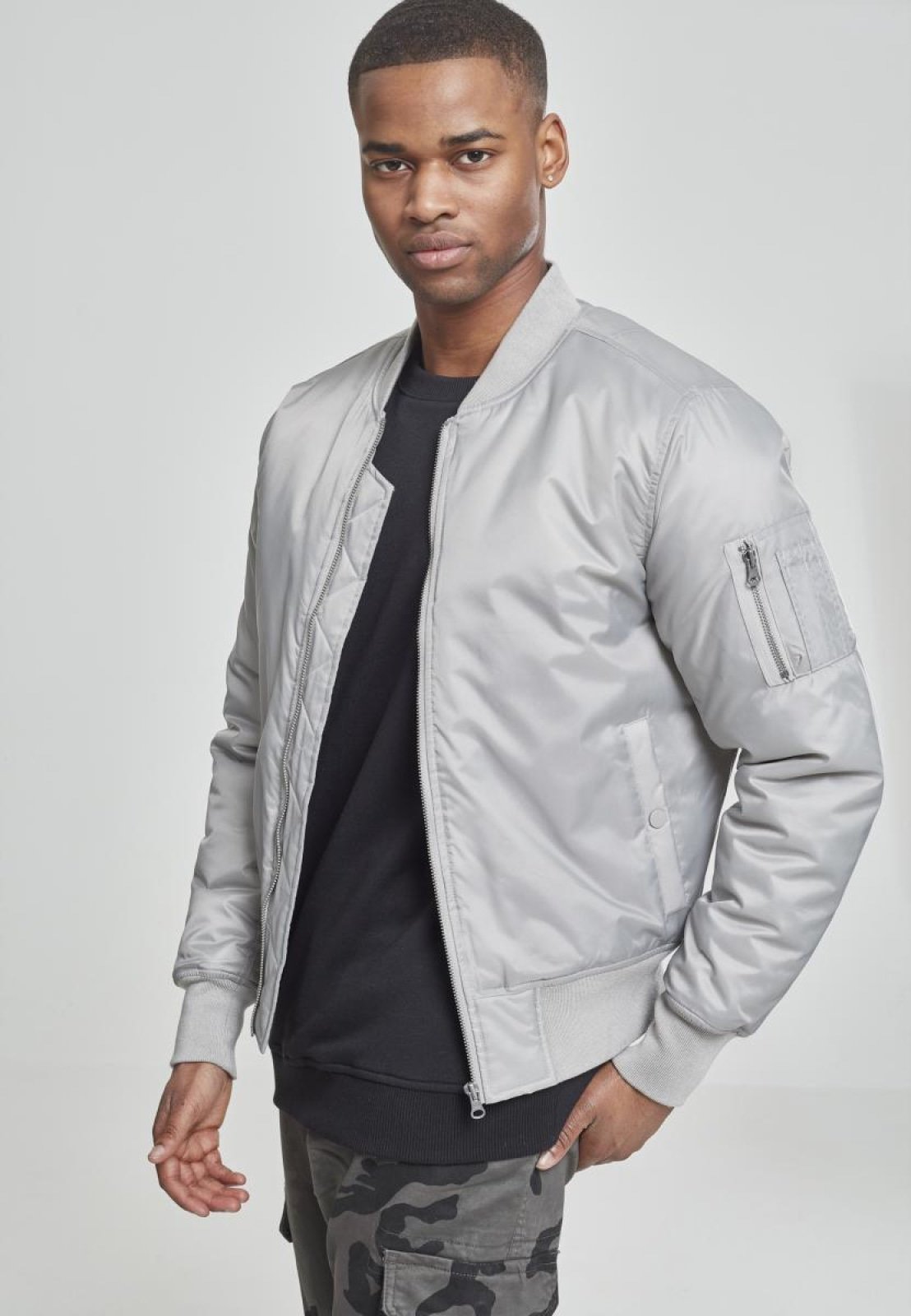 Basic Bomber Jacket featuring orange lining and zippered arm pocket, available in various colors.