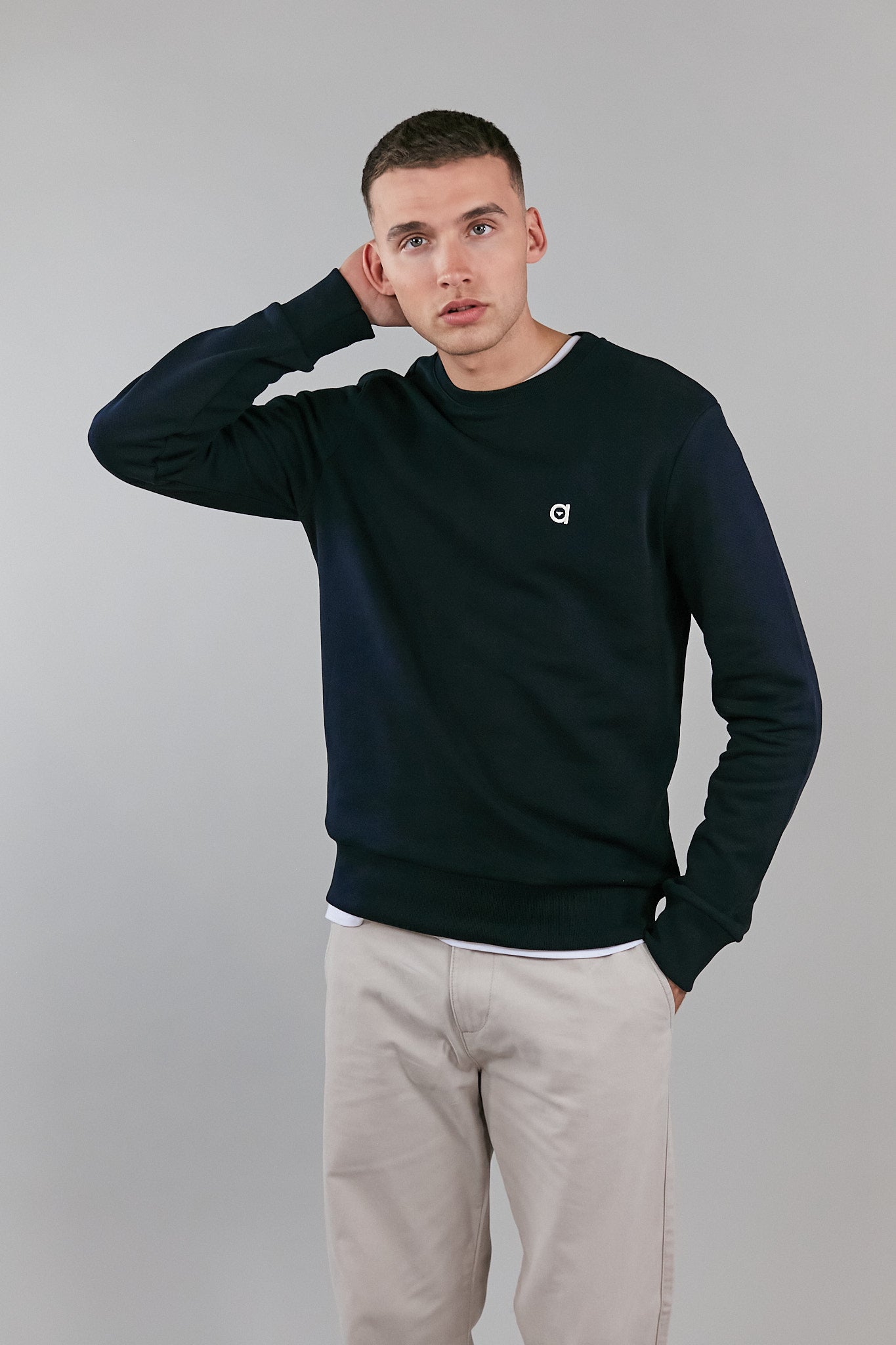 A stylish black crew neck sweatshirt made from 100% organic cotton, featuring an embroidered altid logo.