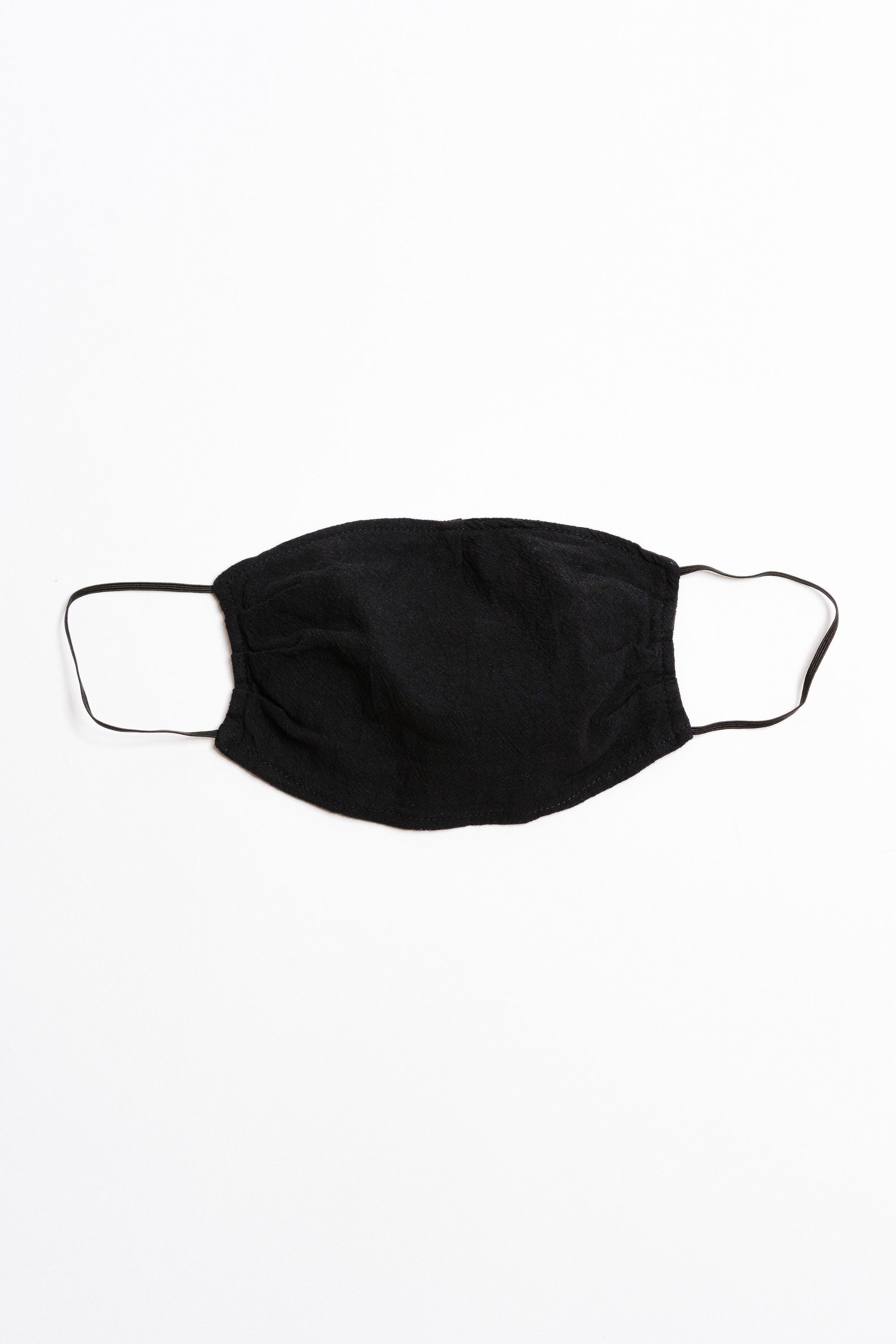 Black textured face mask with black elastic ear straps, designed for comfort and safety, featuring a pocket for filter insertion.