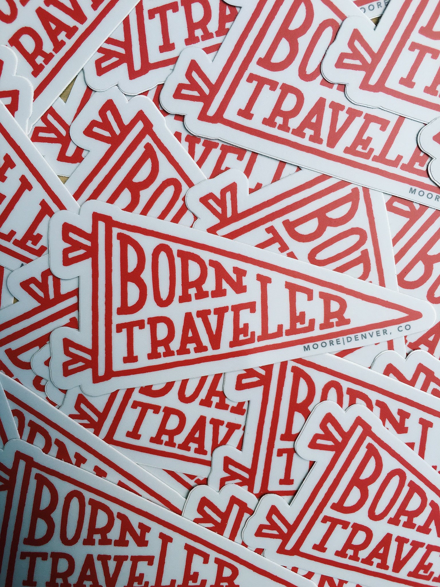 A waterproof vinyl sticker featuring the phrase 'Born Traveler' with a matte finish, ideal for travel enthusiasts.