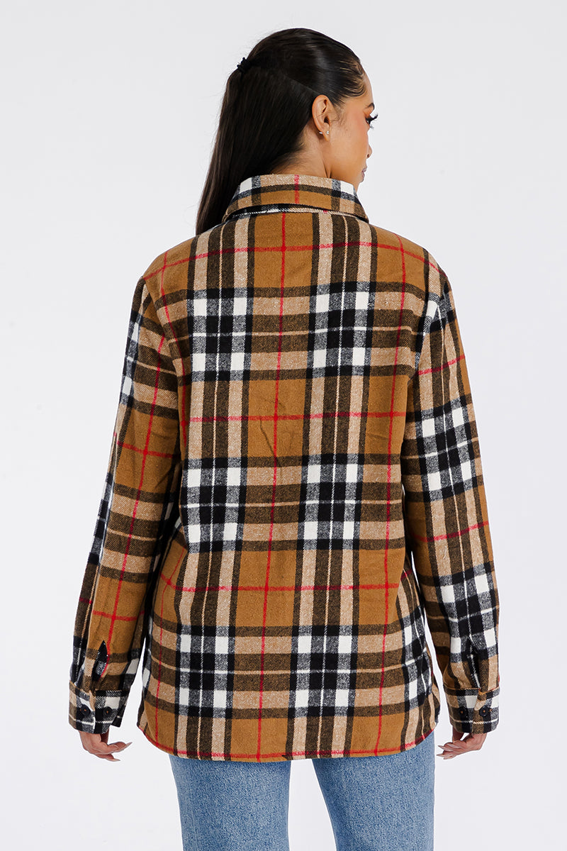 A stylish oversized flannel shacket for women, featuring button closure and chest pockets, made from soft brushed fabric.