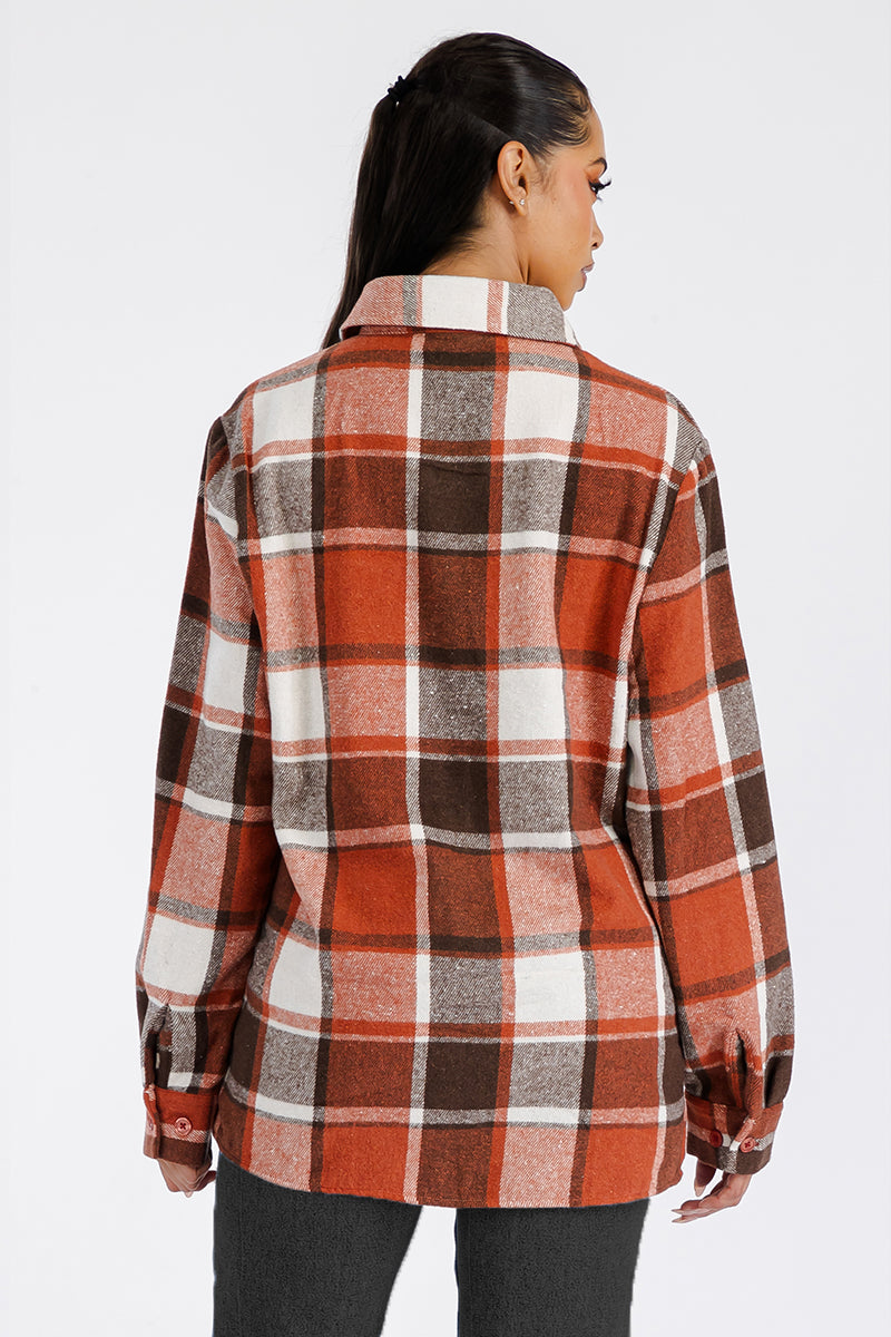 A stylish oversized flannel shacket for women, featuring button closure and chest pockets, made from soft brushed fabric.