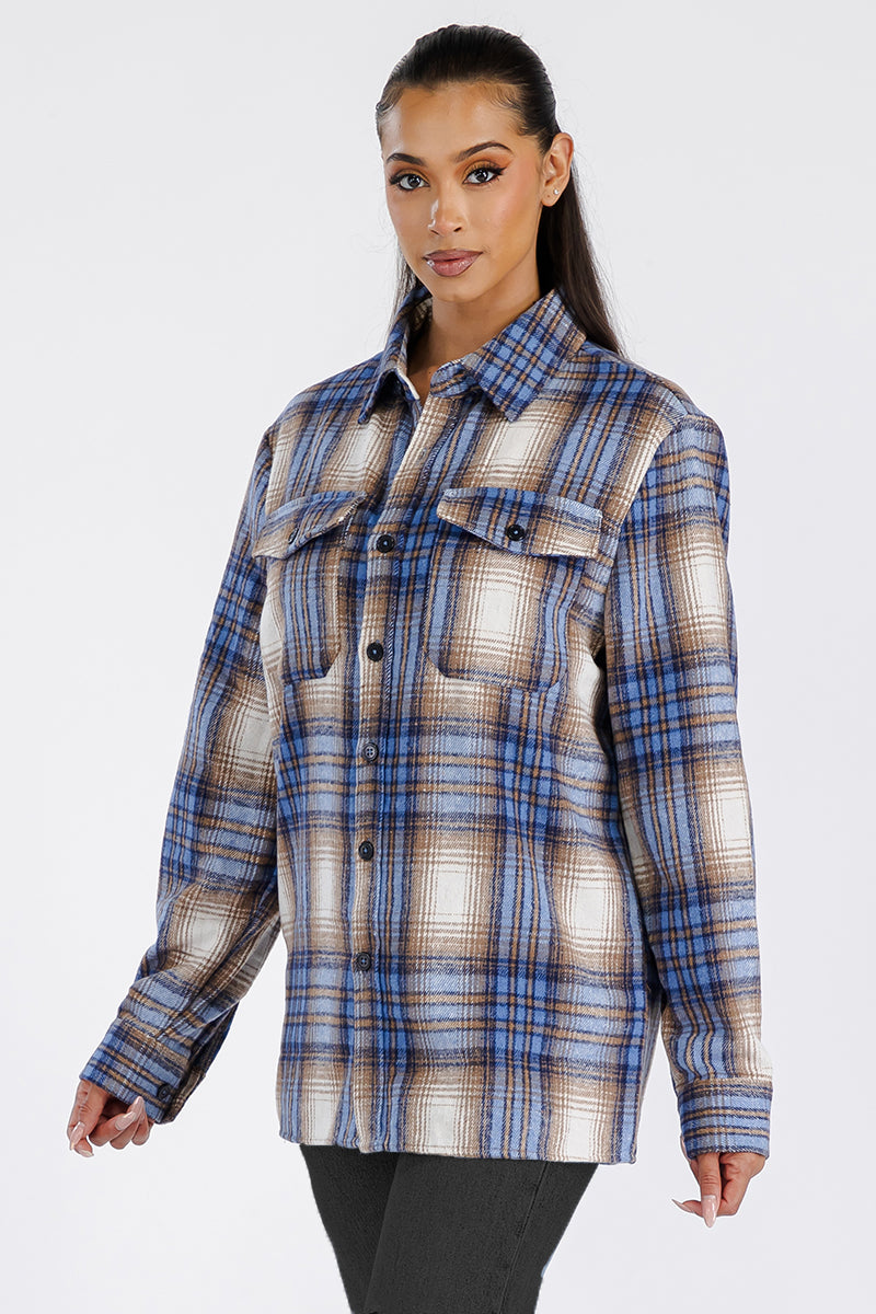 A stylish woman wearing a Boyfriend Oversized Soft Flannel Shacket, featuring button closure and chest pockets, showcasing its soft brushed fabric.