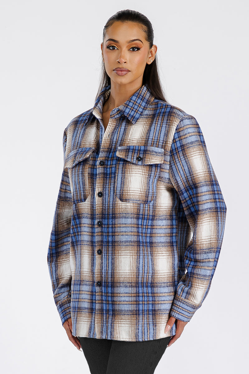 A stylish woman wearing a Boyfriend Oversized Soft Flannel Shacket, featuring button closure and chest pockets, showcasing its soft brushed fabric.