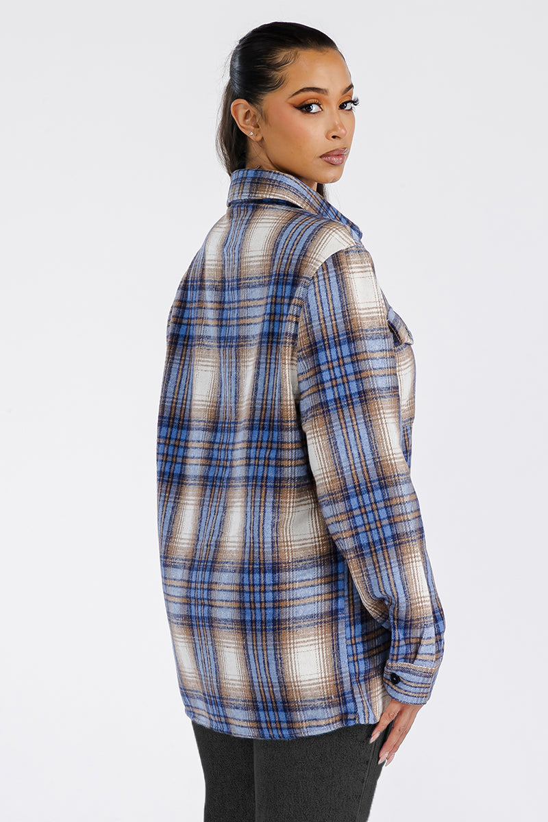 A stylish woman wearing a Boyfriend Oversized Soft Flannel Shacket, featuring button closure and chest pockets, showcasing its soft brushed fabric.