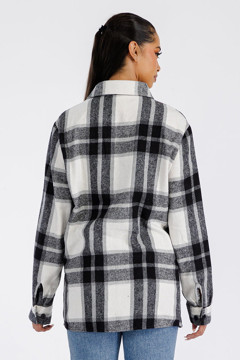 A stylish oversized flannel shacket for women, featuring button closure and chest pockets, made from soft brushed fabric.