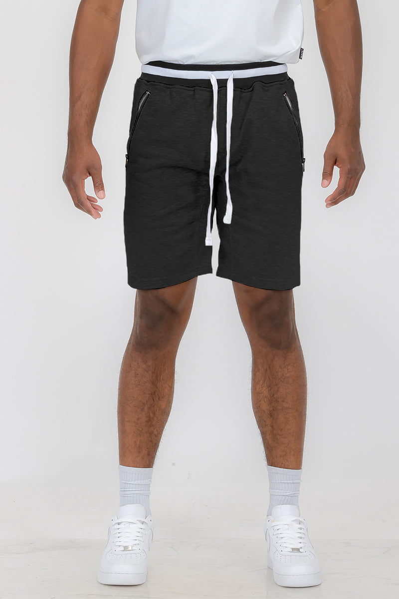 Man wearing black drawstring shorts.