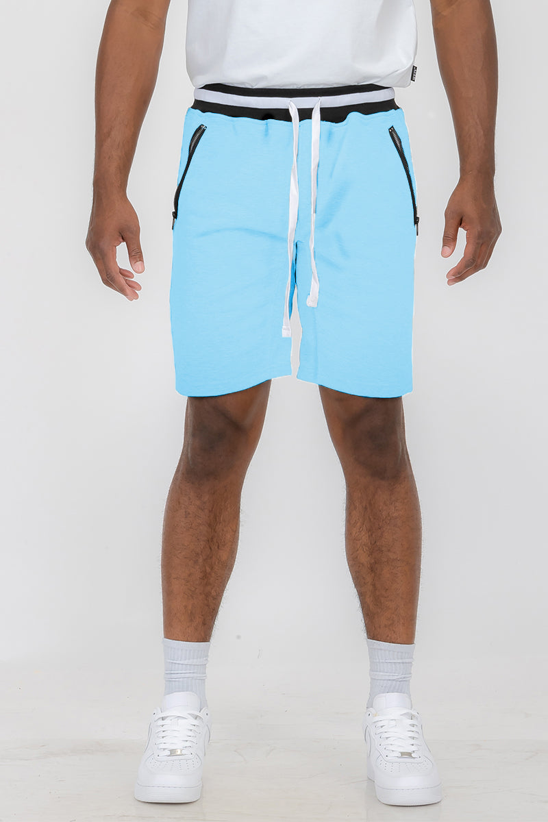 Person wearing blue athletic shorts.