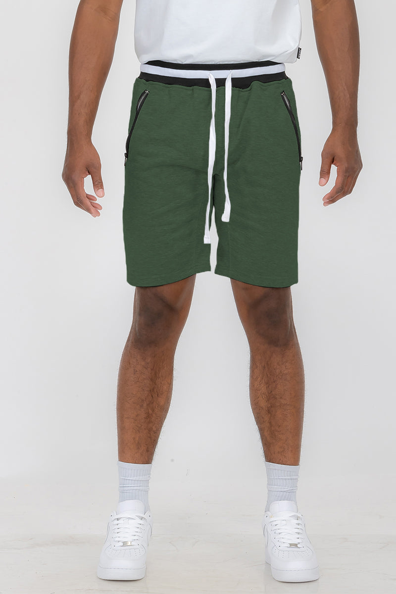 Man wearing green drawstring shorts.