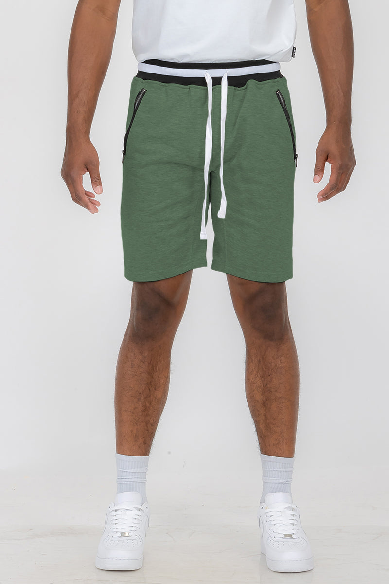 Green shorts with white drawstring.