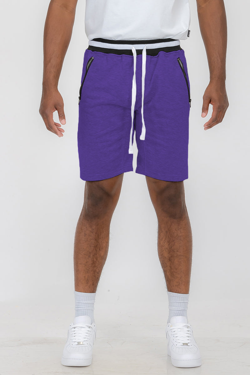 Person wearing purple drawstring shorts