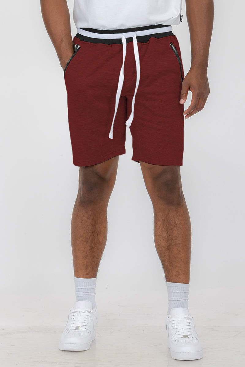 Man wearing red drawstring shorts.