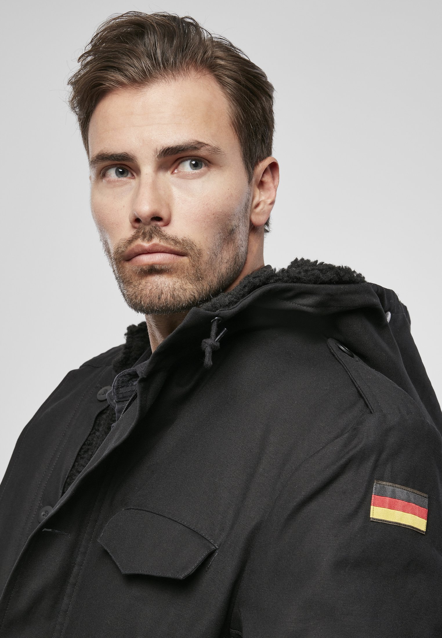 BW Parka featuring a large hood, adjustable waist, and military insignia, perfect for winter wear.