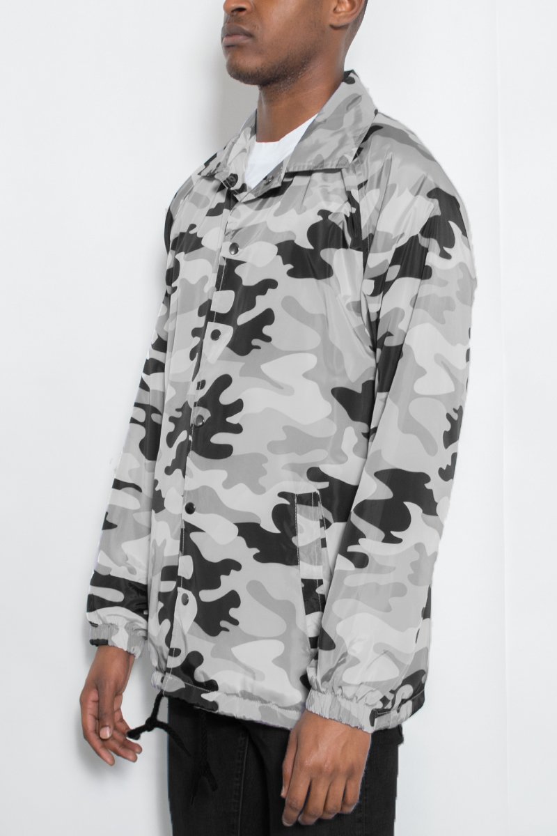 CAMO COACHS JACKET featuring a camouflage design, snap button closure, and multiple pockets, perfect for outdoor activities.