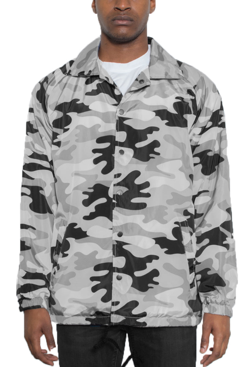 Camo Coachs Jacket featuring a camouflage pattern, snap button closure, and multiple pockets, ideal for outdoor activities.