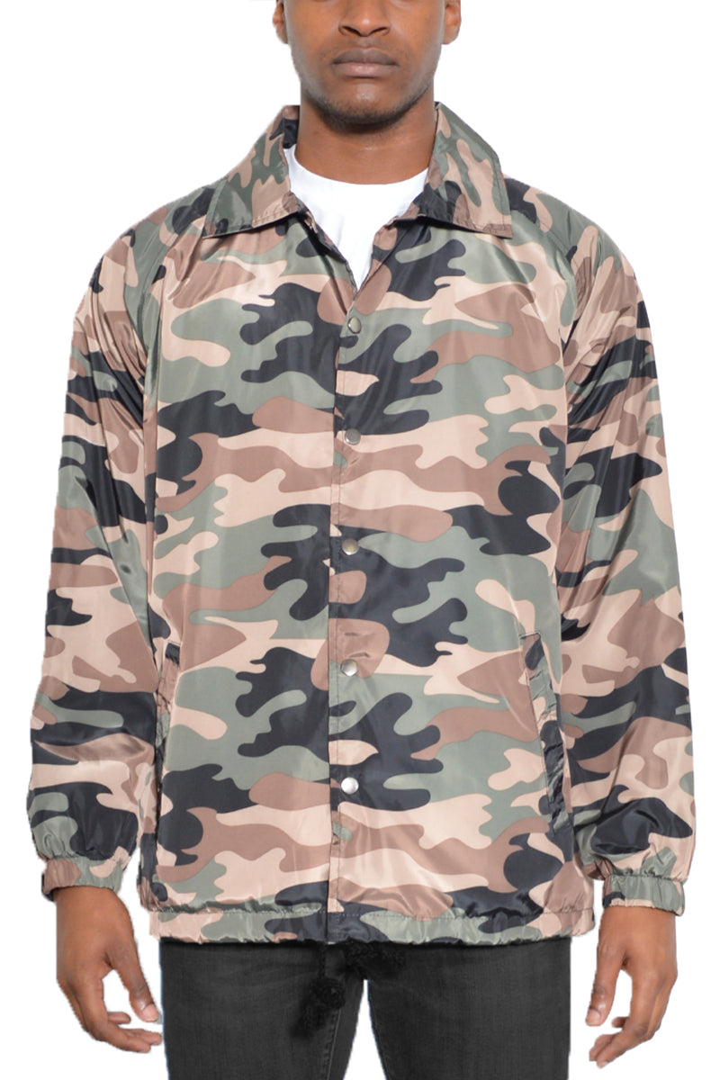 Camo Coachs Jacket featuring a camouflage pattern, snap button closure, and multiple pockets, ideal for outdoor activities.