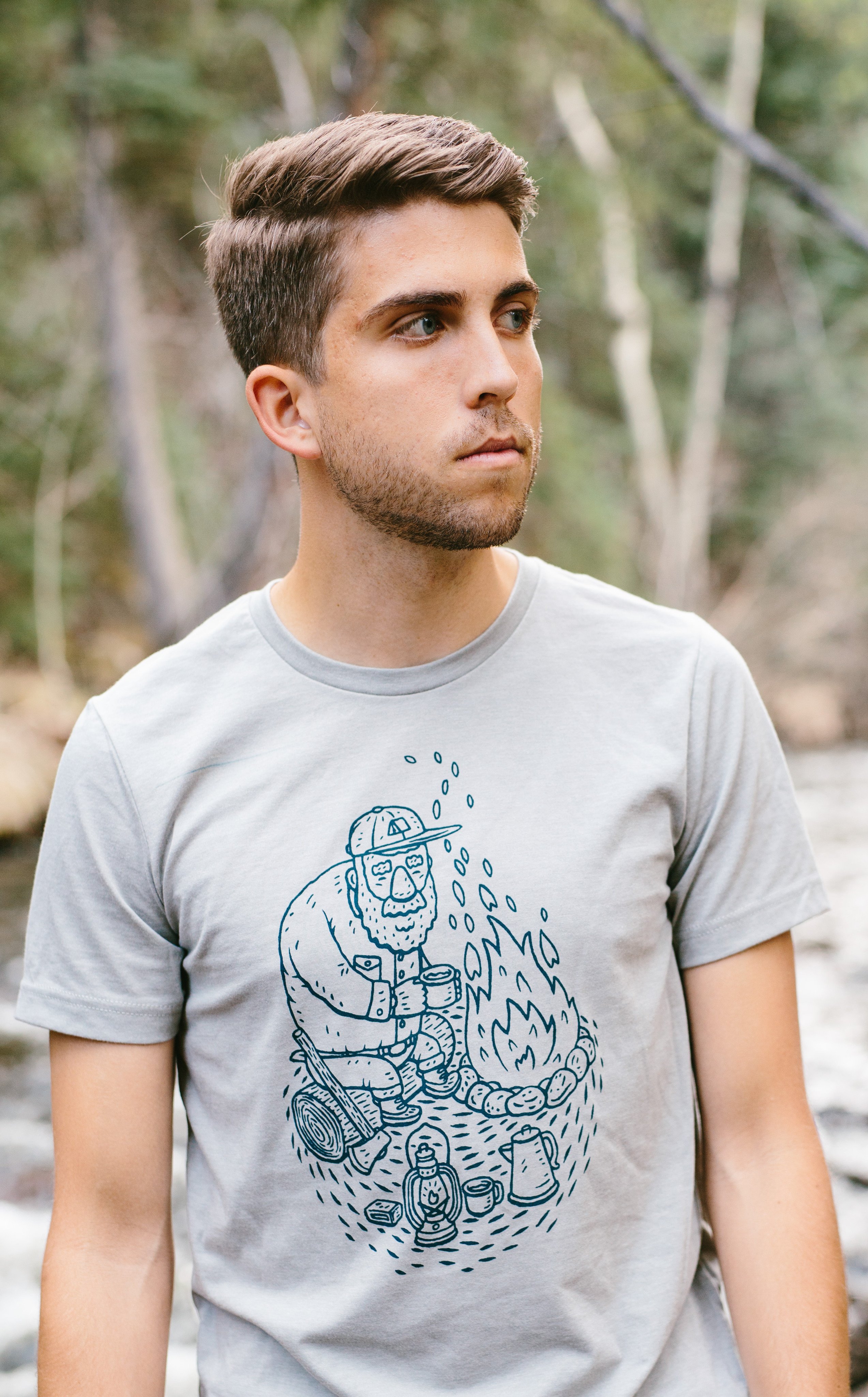 Gray Campfire Tee featuring a navy screen printed design inspired by camping memories, made from soft ringspun cotton.