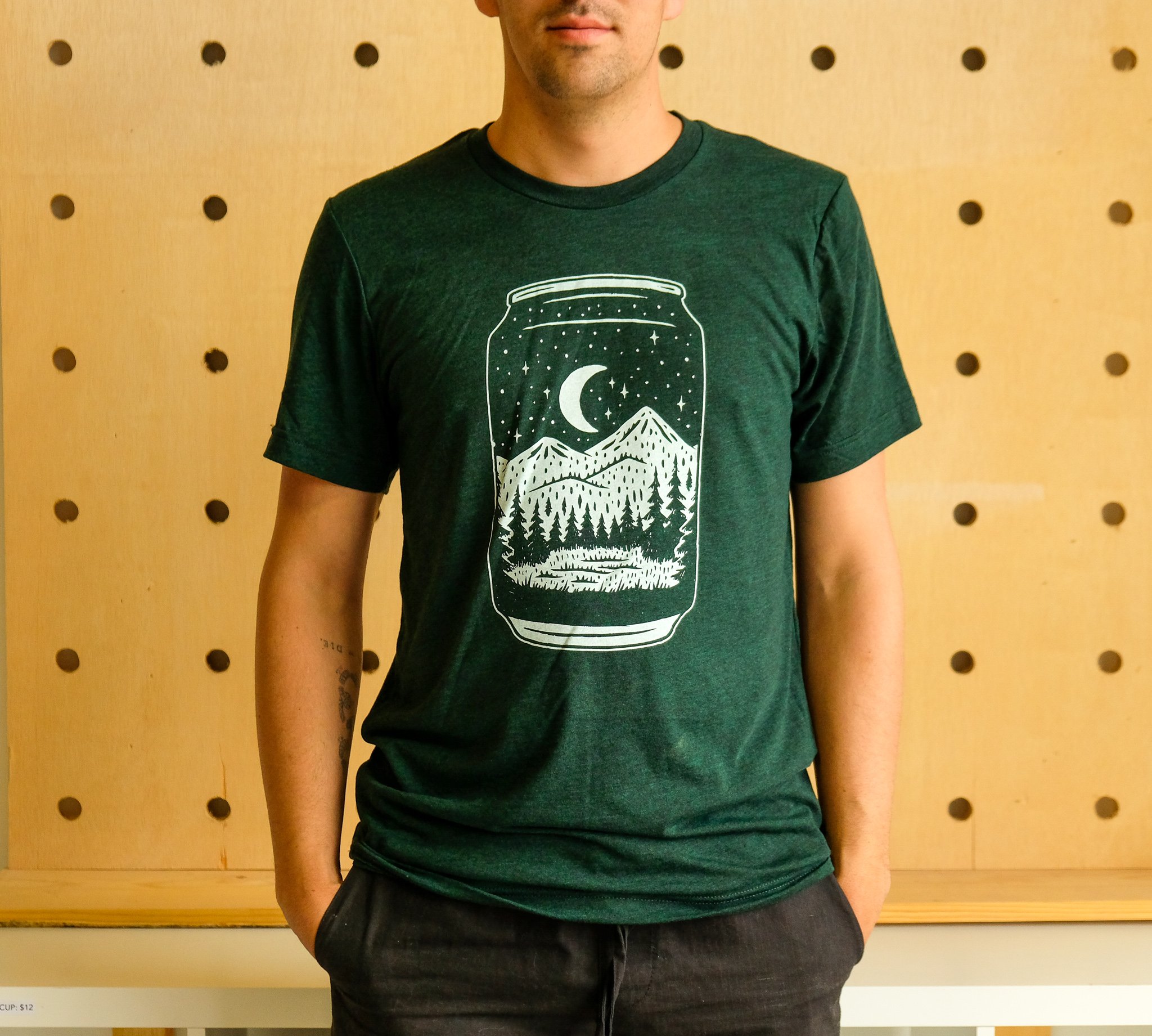 Emerald green Can Tee t-shirt featuring a night forest design, made from a soft tri-blend fabric.